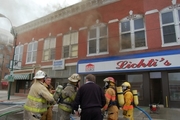 Lichti's building on fire with crew gathered out front