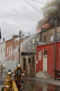 two firefighters working a building fire