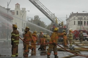 multiple firefighters gathered working fire